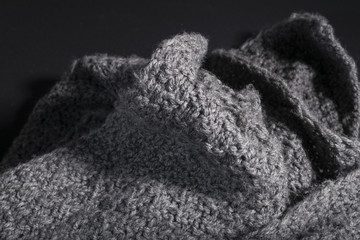 crumpled handmade gray fabric on a dark background.