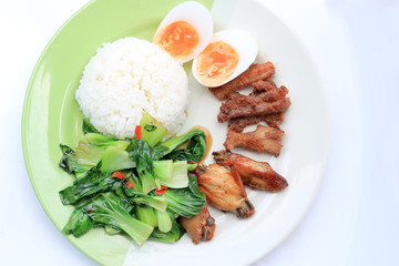 stir fried vegetables, Hard-boiled egg, Fried pork and Fried chicken wings with thai jasmine rice on dish. Thai food.