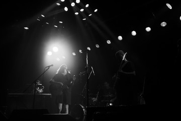 Fototapeta na wymiar Spotlights over band on stage black and white