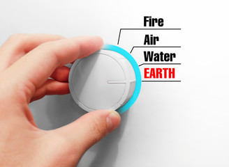 Male hand turns the switch. Switches space. Chose the Earth