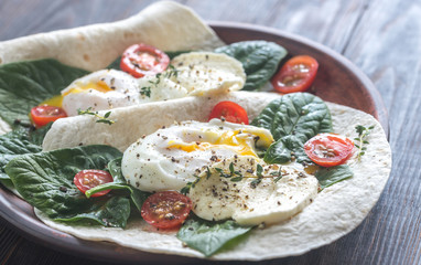 Tortilla sandwiches with poached eggs