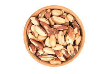 Wooden bowl filled with Brazil nut isolated white background, top view