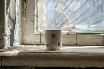 Mug on an old dirty window