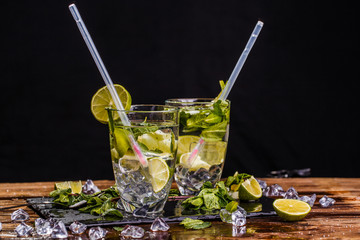Glasses with drink and spoons