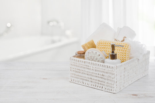 Box with spa products on wood over blurred bathroom interior