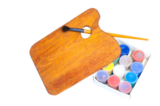 Large brush with paints and malbert on a white background. Isolated