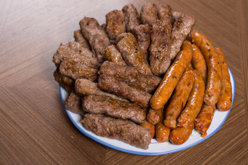 Served kebabs and sausages from bbq on the plate