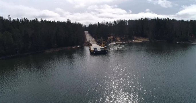 Sk&aring;ld&ouml; cable ferry, Cinema 4k aerial circuling view following a yellow cable ferry, in Skaldo, in the tammisaari archipelago, in Finland