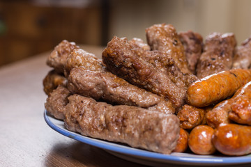 Served kebabs and sausages from bbq on the plate