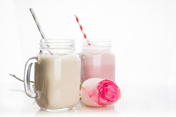Strawberry and banana milkshakes on the white background