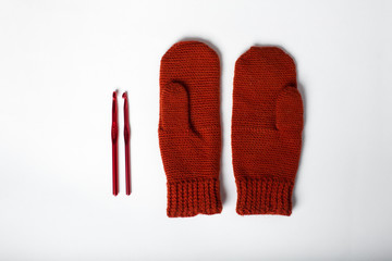 knitted gloves in red on a white background