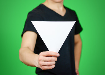 Man showing blank white triangular flyer brochure booklet. Leaflet presentation. Pamphlet hold...