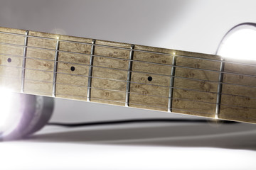 Electric guitar neck fingerboard under studio lighting