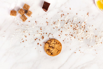 Making chocolate chips cookies, with flour, sugar, and egg