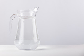 glass jug with water isolated on white background