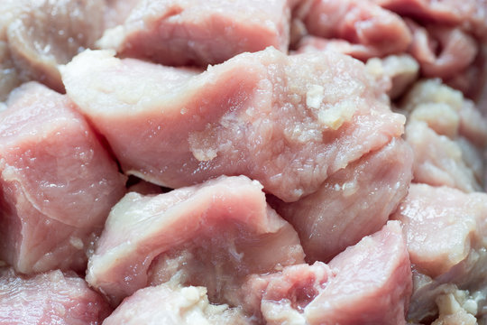Raw slices of pork mea in glass bowl
