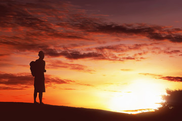 Fototapeta na wymiar Silhouette hiker man with backpack standing enjoying sunset