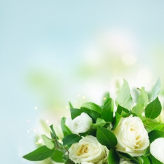 Bouquet with tulips and roses over blue bokeh background