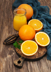 Jar of juice and fresh oranges