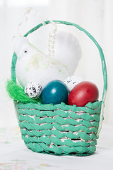 Basket full with colored easter eggs on the table