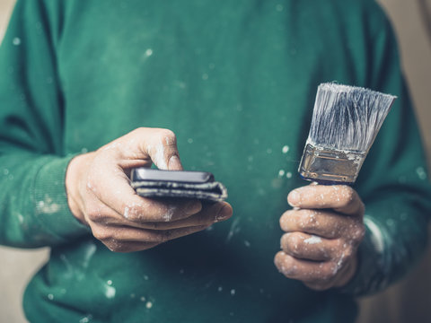 Painter with brush using smartphone