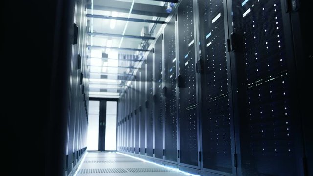 Camera Moves Through Big Working Data Center with Server Racks and Glass Ceiling.  Shot on RED EPIC-W 8K Helium Cinema Camera.