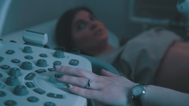 Ultrasound machine doctor s hand usg investigation USCG. Closeup of woman getting an ultrasound scan on abdominal by doctor. Echo machine, ultrasound machine.