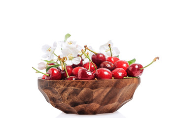Fresh cherry in wooden bowl isolated on white background