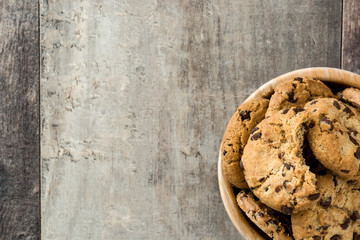 Chocolate chip cookies in wooden bowl on wooden table.Top view 
