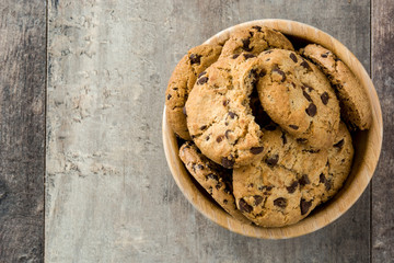 Chocolate chip cookies in wooden bowl on wooden table.Top view 
