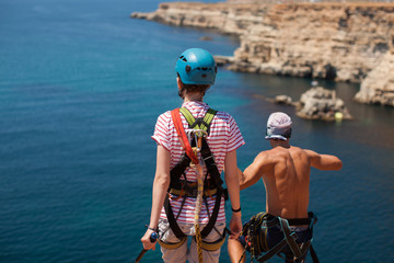 Rope jumping off a cliff with a rope in the water. The ocean. Sea. Mountain.