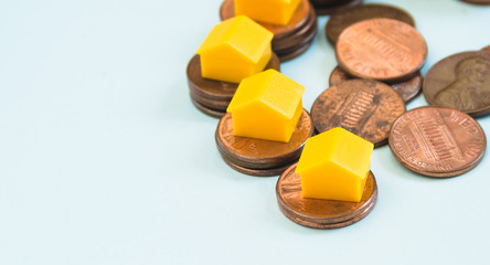Miniature house on 1 Cent coin stacks, real estate and finance concept