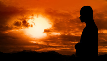 Silhouette of muslim man praying