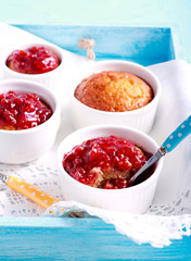 Coconut and raspberry puddings in ramekins