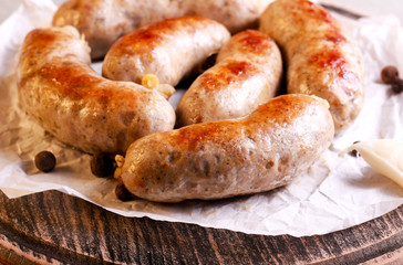 Fried homemade sausages, on board