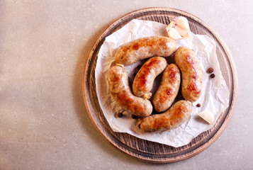 Fried homemade sausages, on board