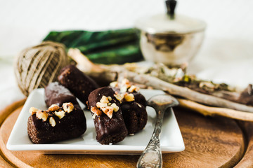 Candy with peanuts, honey and chocolate, homemade raw healthy dessert