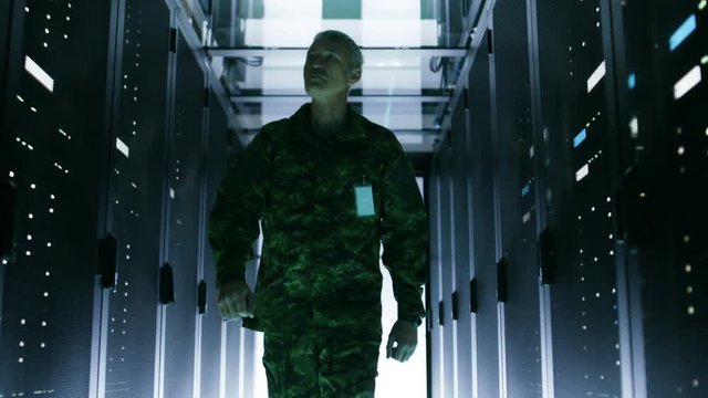 Military Man Walks Through Data Center with Working Rack Servers.  Shot on RED EPIC-W 8K Helium Cinema Camera.