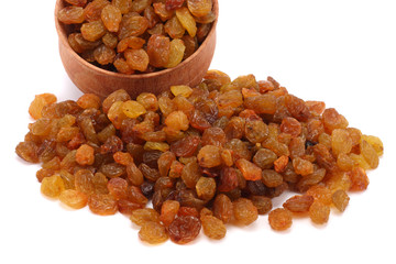 Organic dried Raisins in wood plate isolated on white background