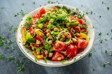Chickpea salad with tomato, avocado, basil and olive oil