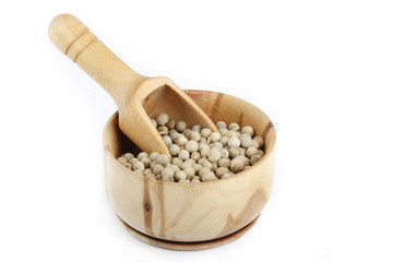 white peppercorn in wooden cup isolated on white background
