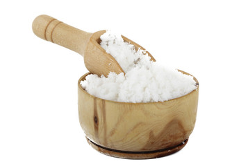 Dried grated coconut in wooden cup isolated on white background
