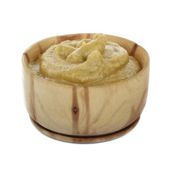 mustard in wooden cup isolated