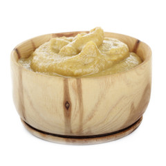 mustard in wooden cup isolated