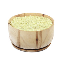 ground dried rind of lime in wooden cup isolated