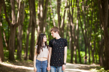Beautiful couple taking a walk in the forest. Lifestyle and relationship. Young inlove boyfriend and girlfriend