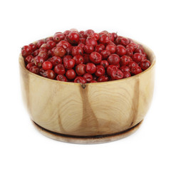 pink peppercorn in wooden cup isolated