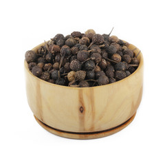 cubeba peppercorn in wooden cup isolated