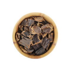 carob in wooden cup isolated
