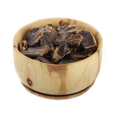 carob in wooden cup isolated